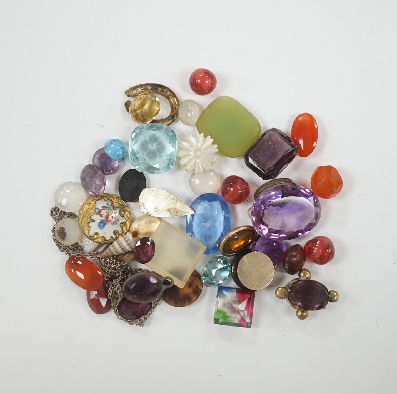 A small quantity of loose cut and cabochon gemstones including carnelian, white opal etc.